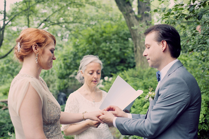 groomputting ring on bride's finger