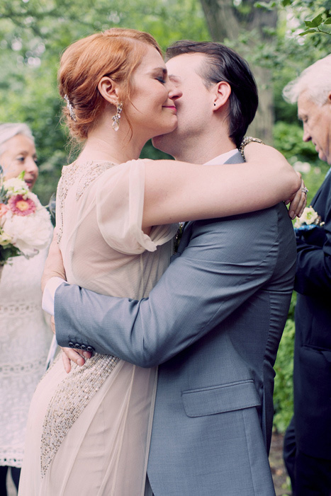 bride and groom hugging after first kiss