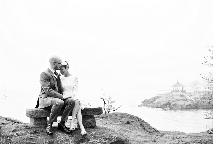 bride and groom sitting on a bench