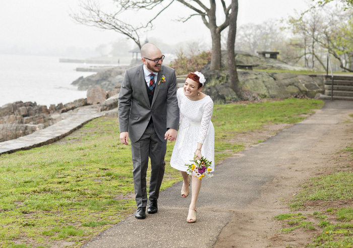 bride and groom walking in the park