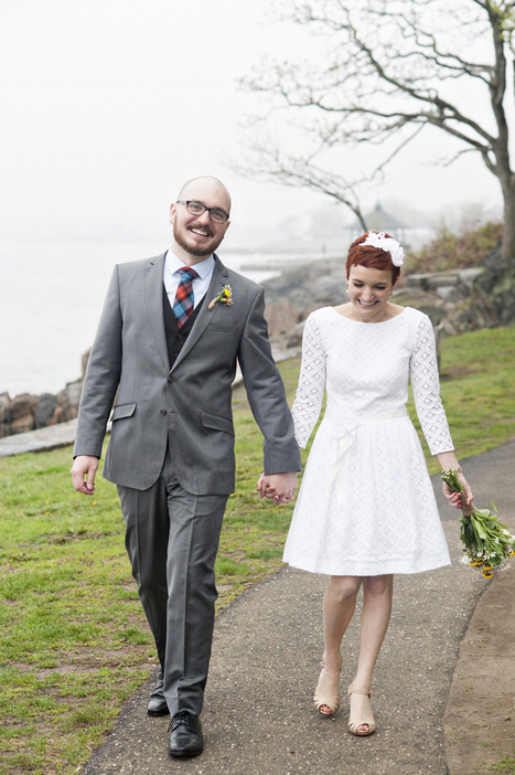 bride and groom walking through the park