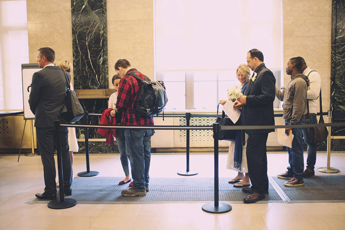 bride and groom waiting line at city hall