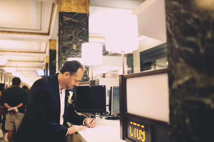 groom signing marriage licence