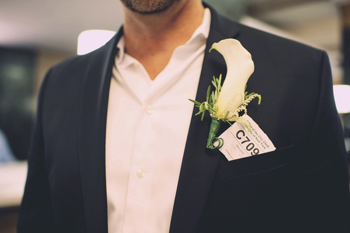 groom with lily boutonniere
