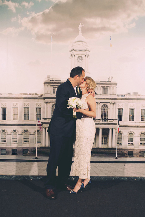 bride and groom kissing at city hall