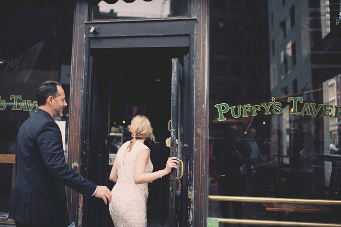 bride and groom entering NYC pub