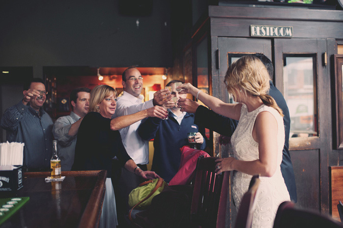 bride and groom toasting with pub patrons