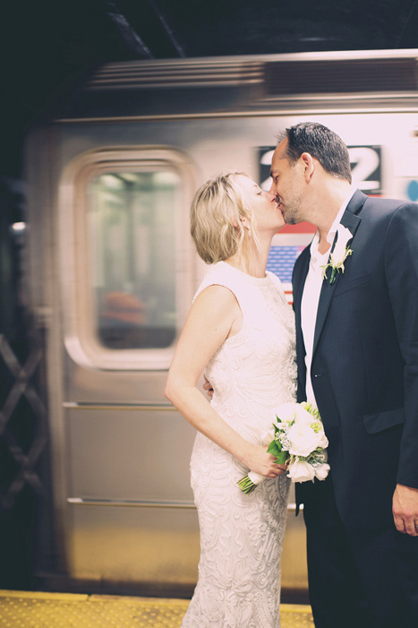 bride and groom in front in subway