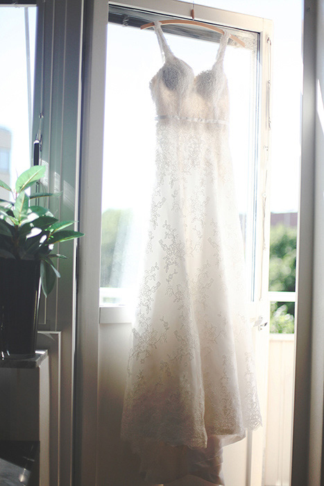 wedding dress hanging in doorway