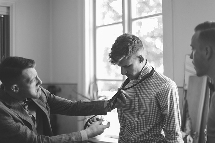 groom tying his tie