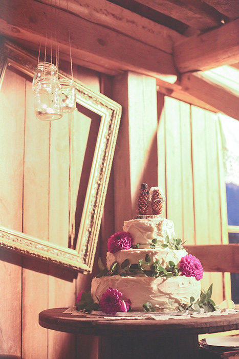 tiered white wedding cake with pink flowers