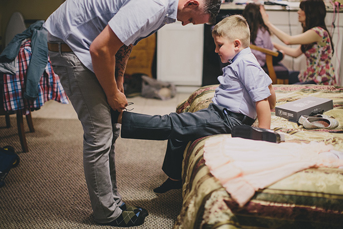 groom tying son's shoes