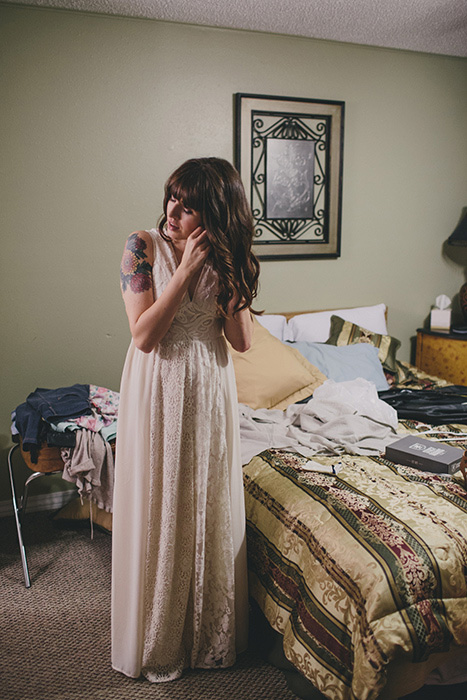 bride putting on earrings