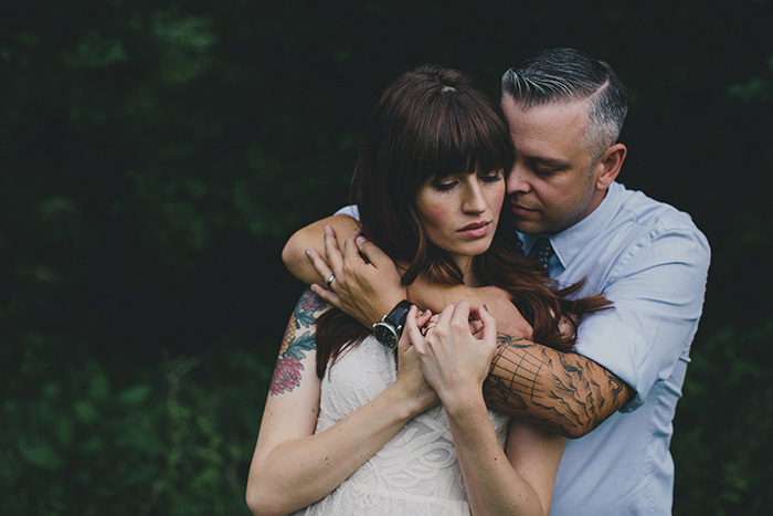 groom standing behind bride with his arms around her