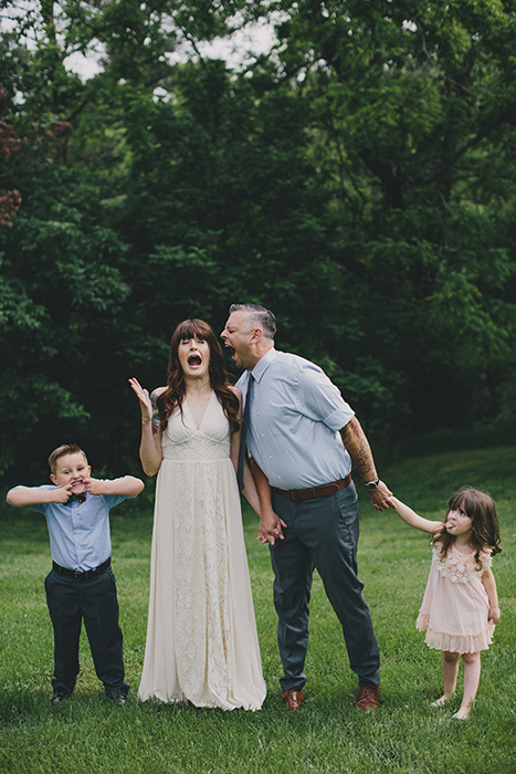 bride and groom being goofy with kids