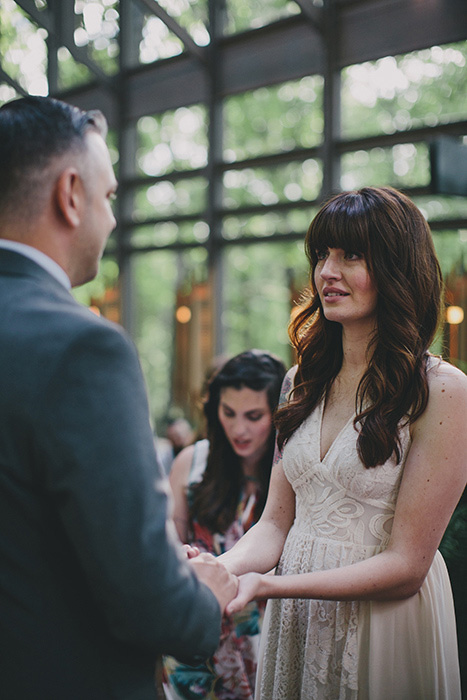 bride and groom holding hands during ceremony