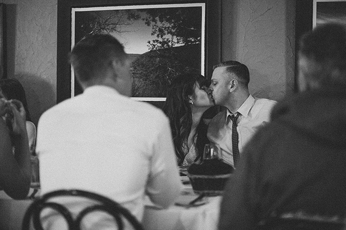 bride and groom kissing at reception