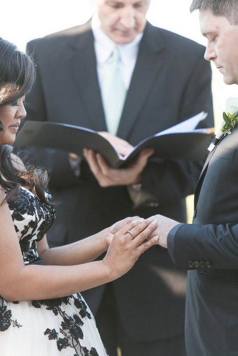 bride and groom holding hands during ceremony