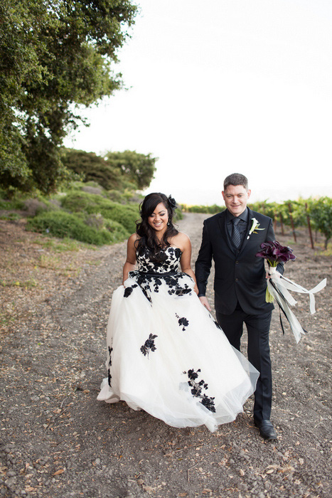 bride and groom walking in vineyard