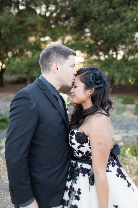 groom kissing bride on forehead