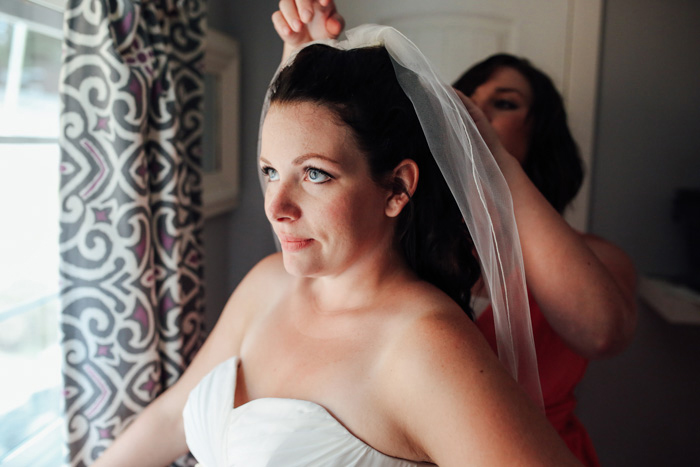 bride putting on her veil