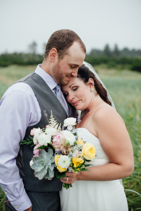 bride resting head on groom's chest