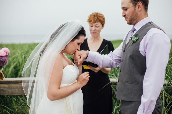 bride kissing groom's hand