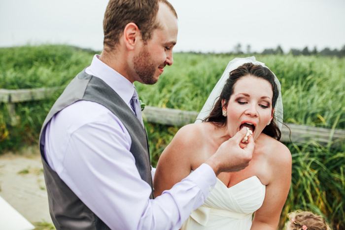 groom feeding bride cake