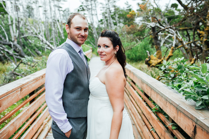 bride and groom on wooden bridge