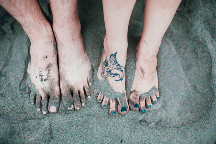 couple's feet in the sand