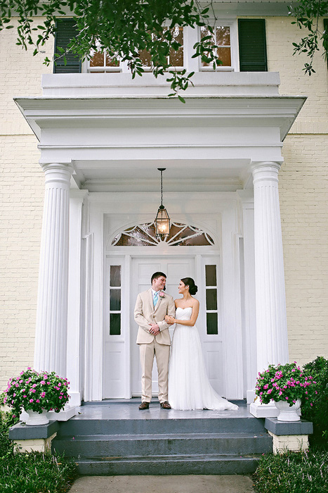 bride and groom on front step of estate