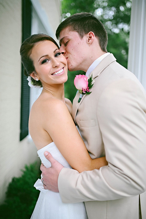 groom kissing bride's cheek