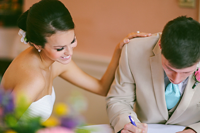 groom signing marriage certificate