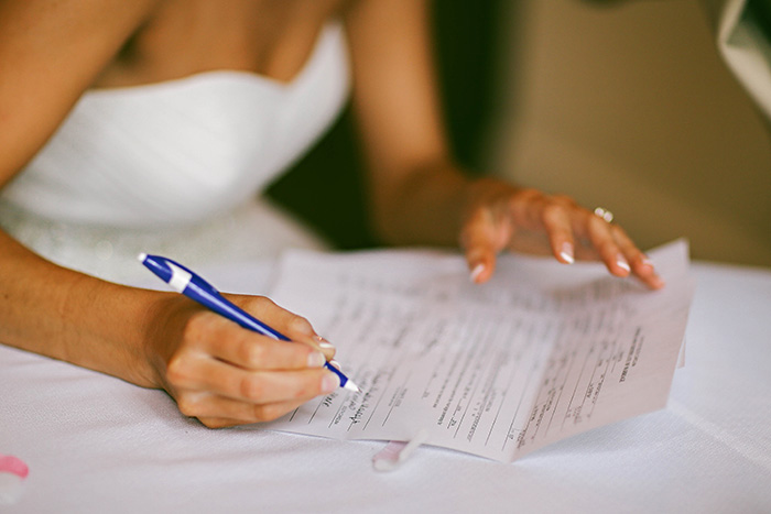 bride signing marriage certificate