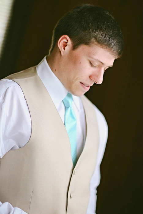 groom in beige vest and turquoise tie