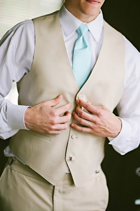 groom buttoning vest