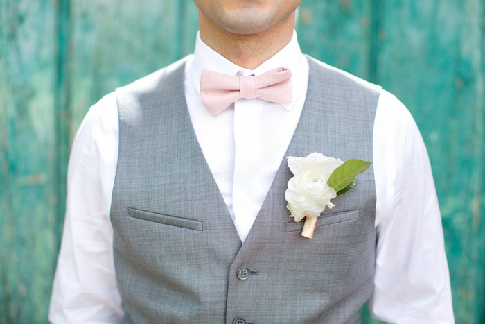 groom in grey vest and pink bow tie