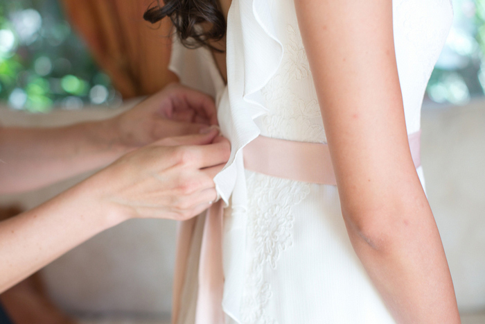 zipping bride's dress