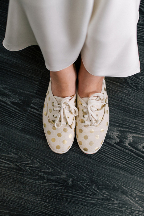 bride in gold polka dot sneakers