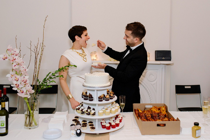 groom feeding bride cake