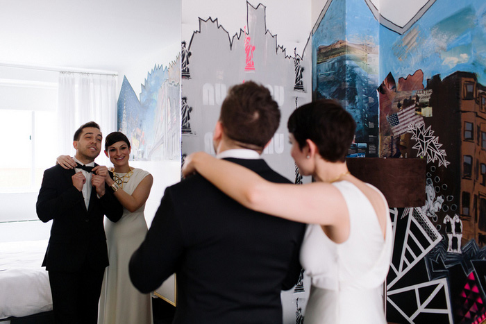 bride helping groom get ready