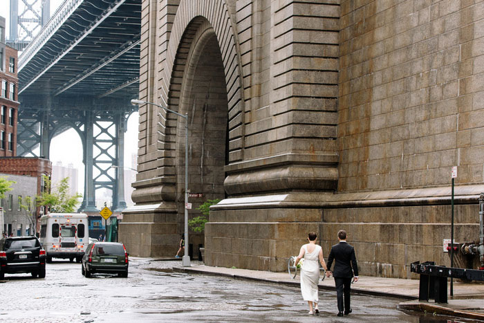 bride and groom walking by brooklyn bridge