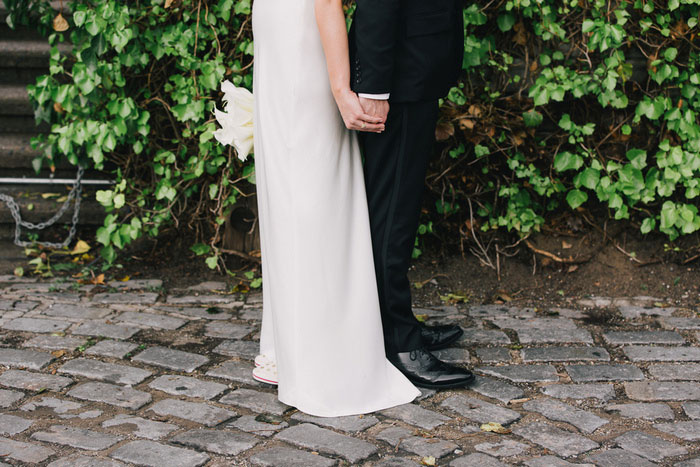 bride and groom holding hands