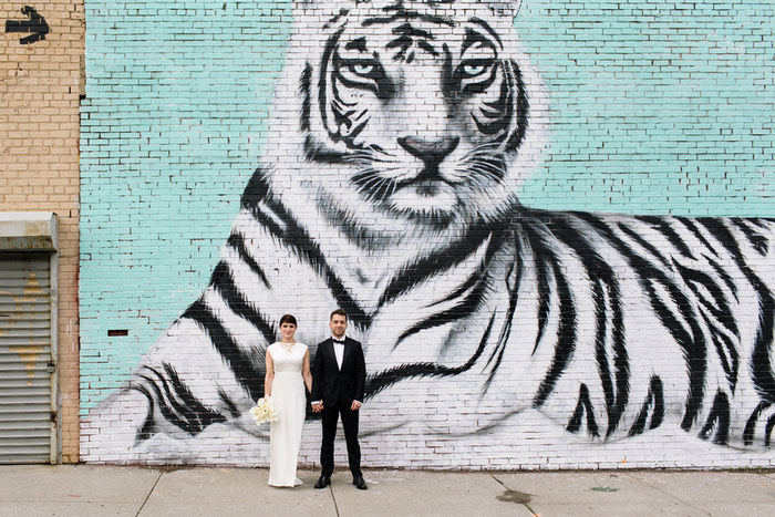 wedding portrait in front of tiger mural