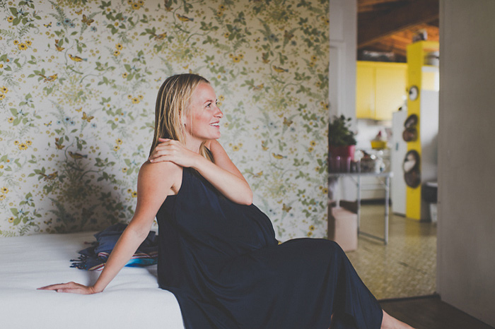 pregnant bride sitting on bed