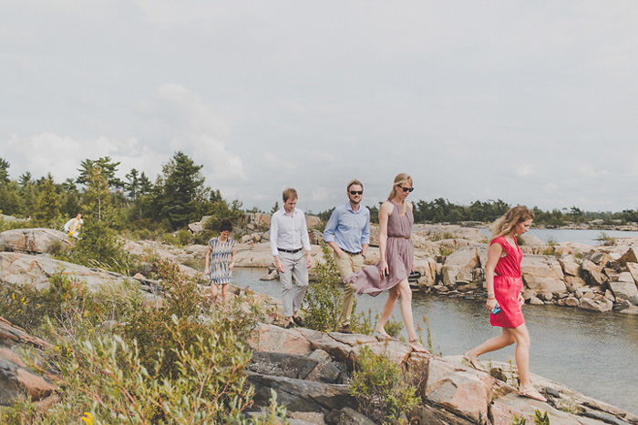 wedding guests walking on rocks