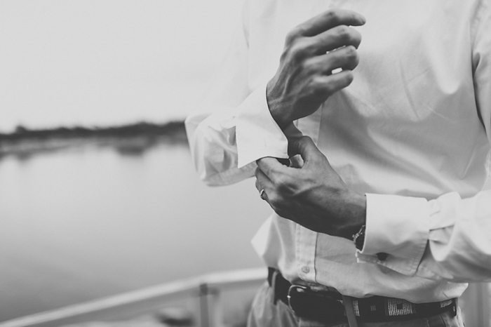 groom buttoning his cuff