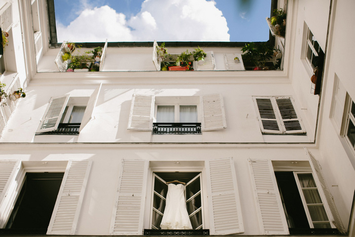 wedding dress hanging in Paris window