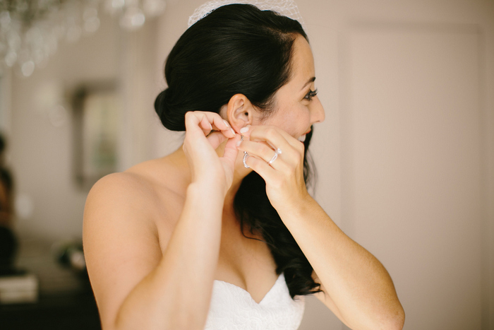 bride puttingon earrings