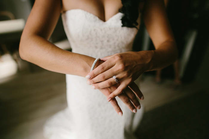 bride putting on bracelet